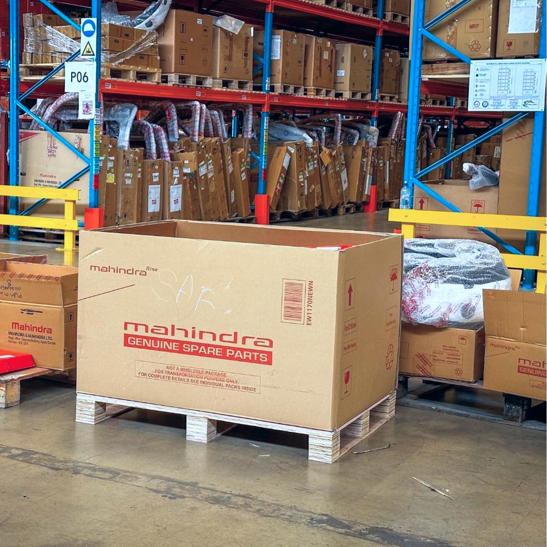 Mahindra genuine spare parts box on a pallet in the warehouse
