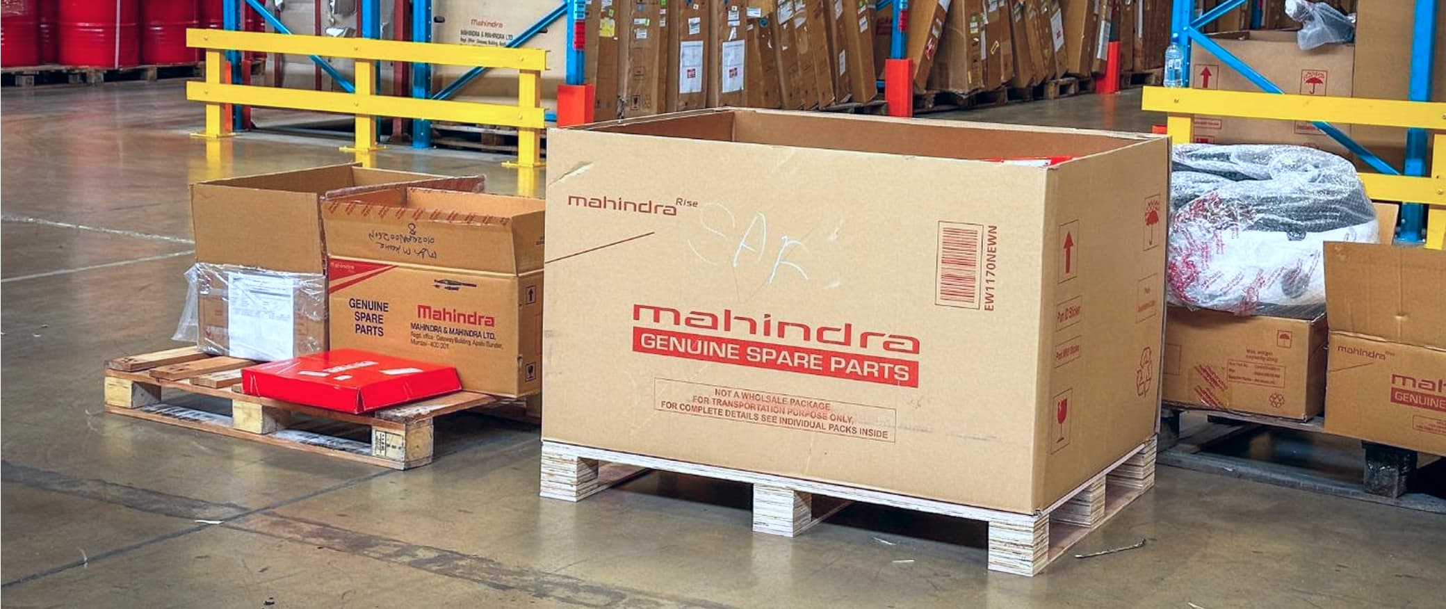 Mahindra genuine spare parts box on a pallet in the warehouse