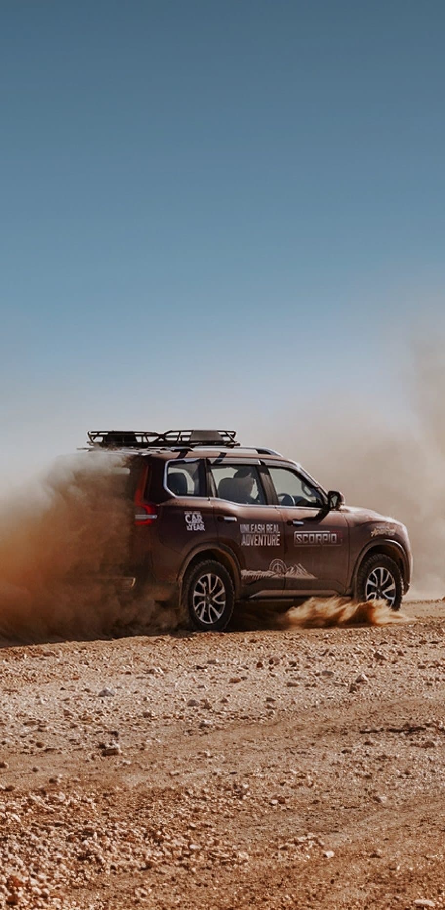 Mahindra Scorpio-N kicking up dust on a Namibian gravel road