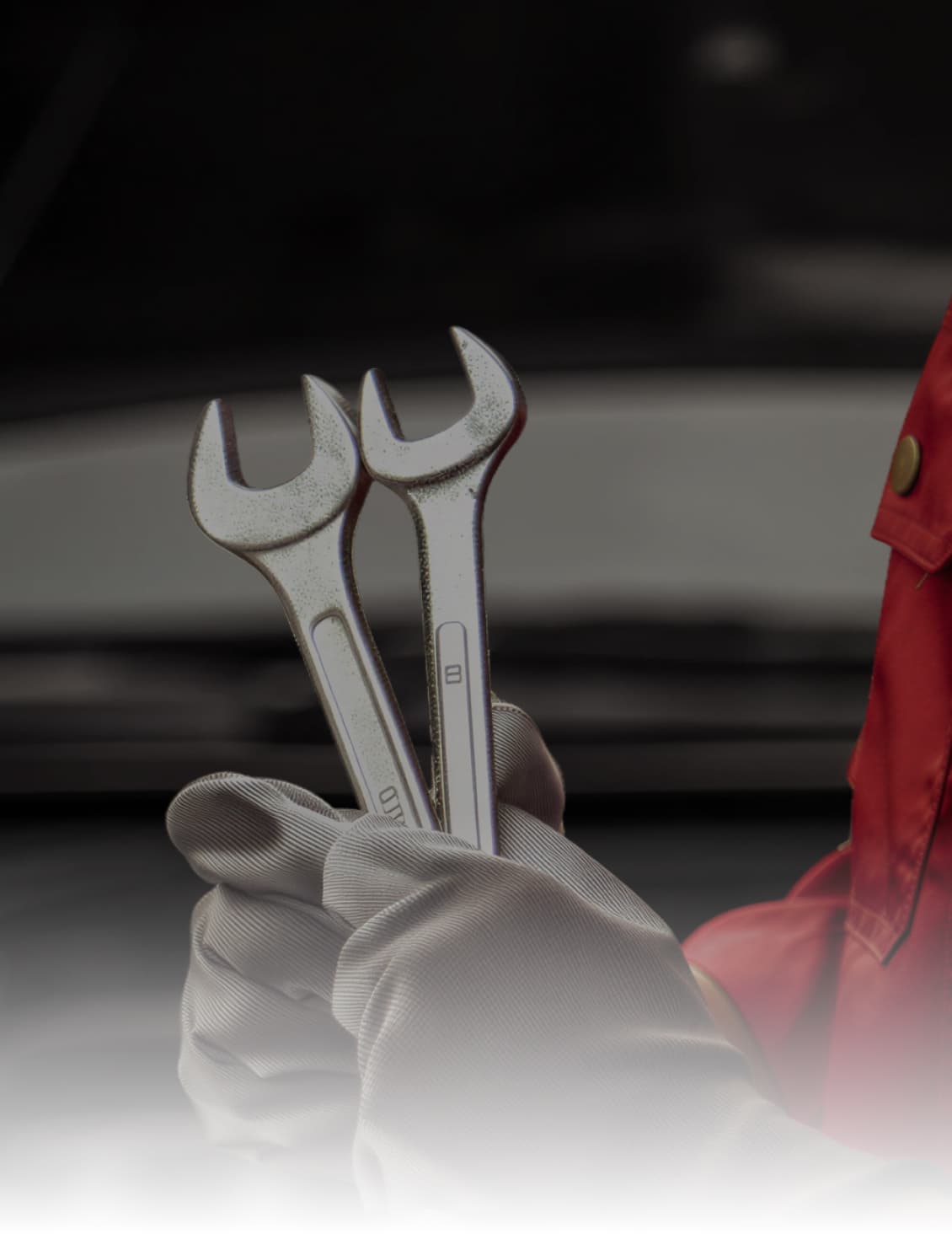 Mahindra technician holding wrenches