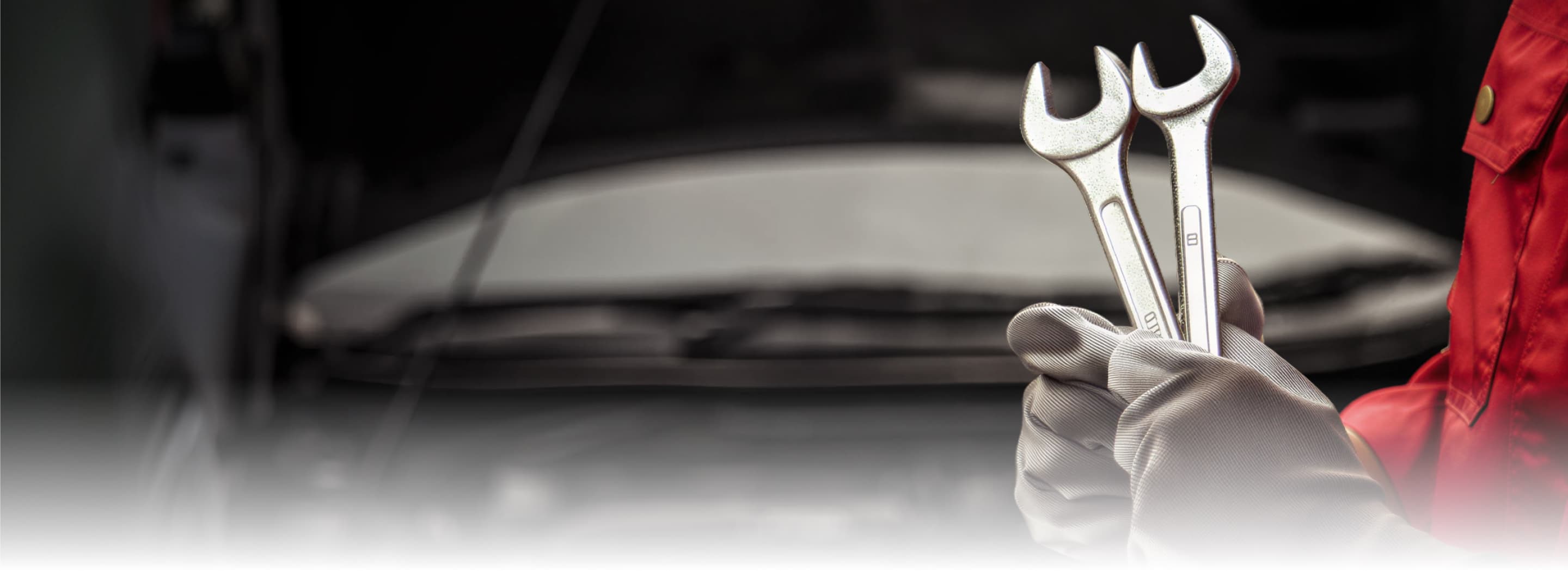 Mahindra technician holding wrenches