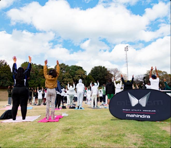 Community yoga session outdoors at Randburg Cricket Club