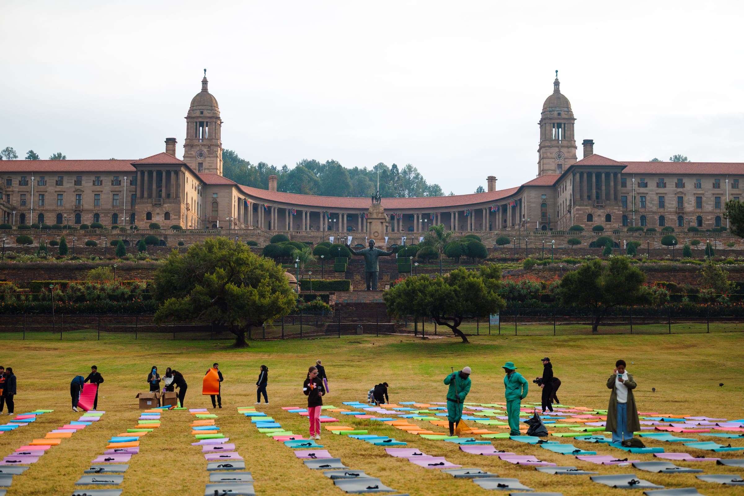 Rows of colourful yoga mats on the lawns facing the Union Buildings