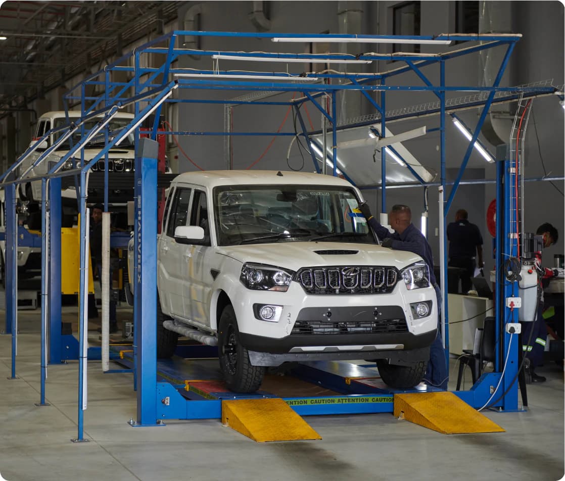 Mahindra vehicle on a lift inside the central parts and service facility